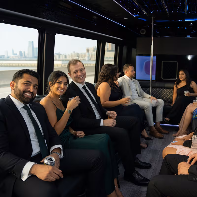 Wedding guests seated inside a Newark party bus