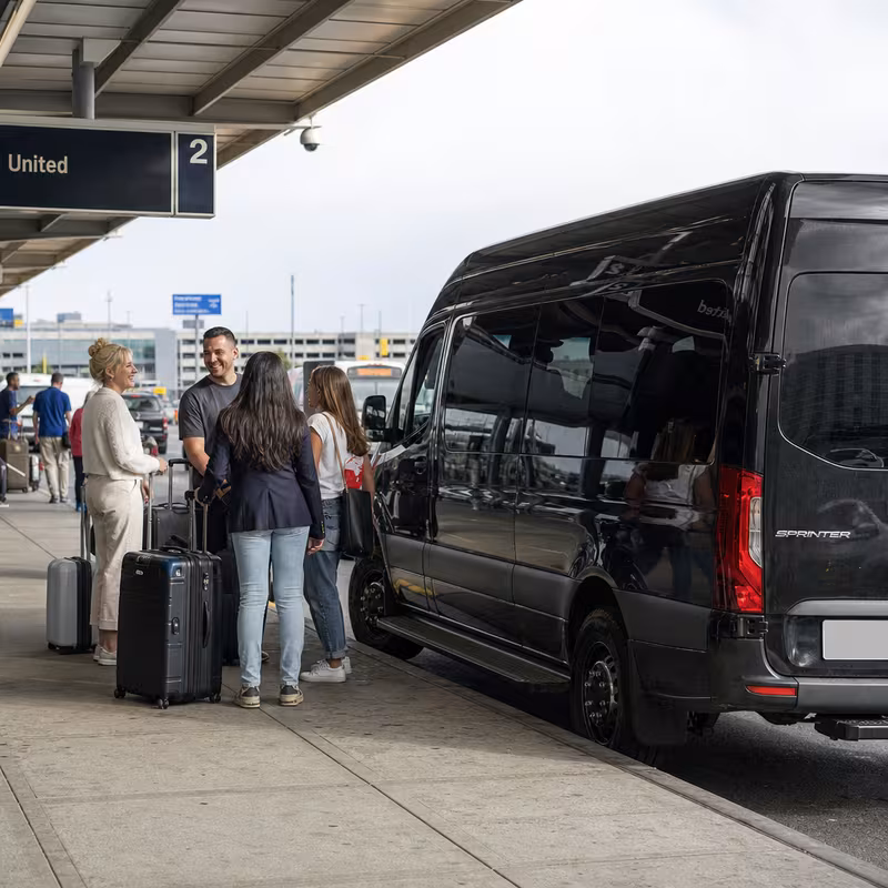 Group boarding a white charter bus for Airport Transportation transportation in Newark