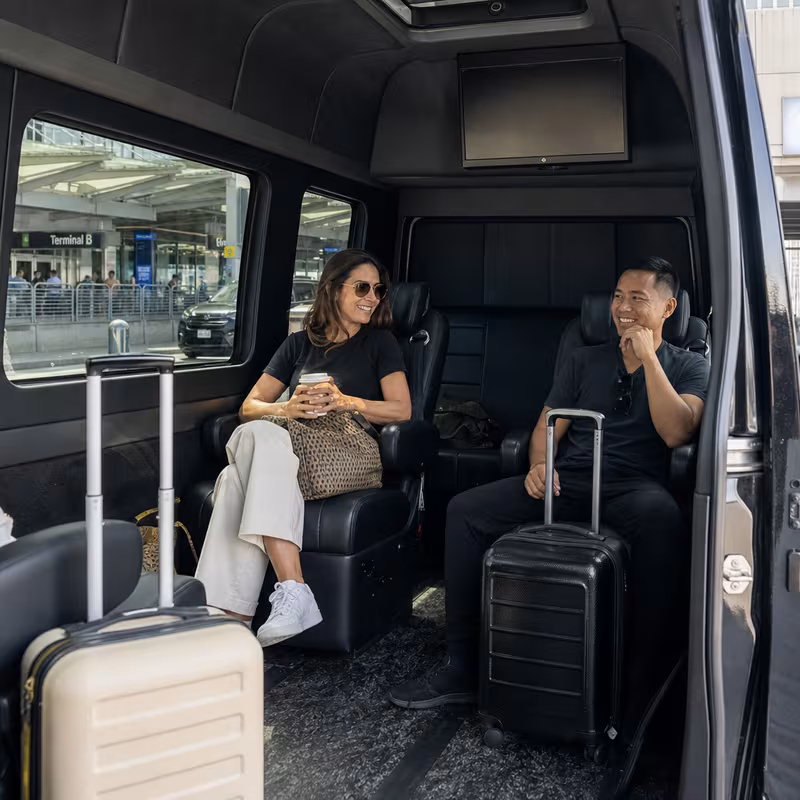 Passengers loading luggage while boarding an Newark group shuttle