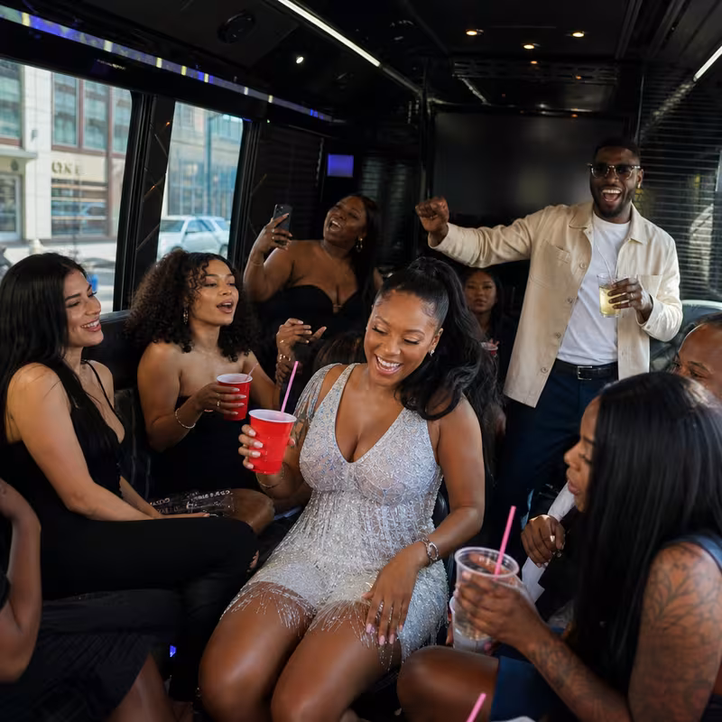 Party bus interior with wraparound leather seating and LED lighting in Newark