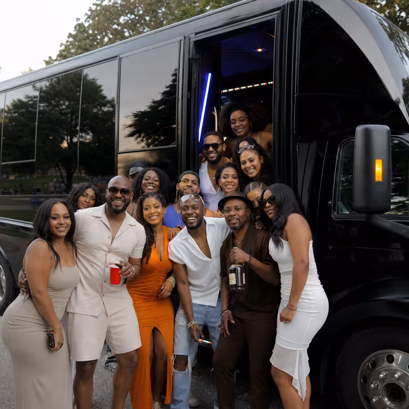 Group boarding a white charter bus for Birthday Transportation transportation in Newark