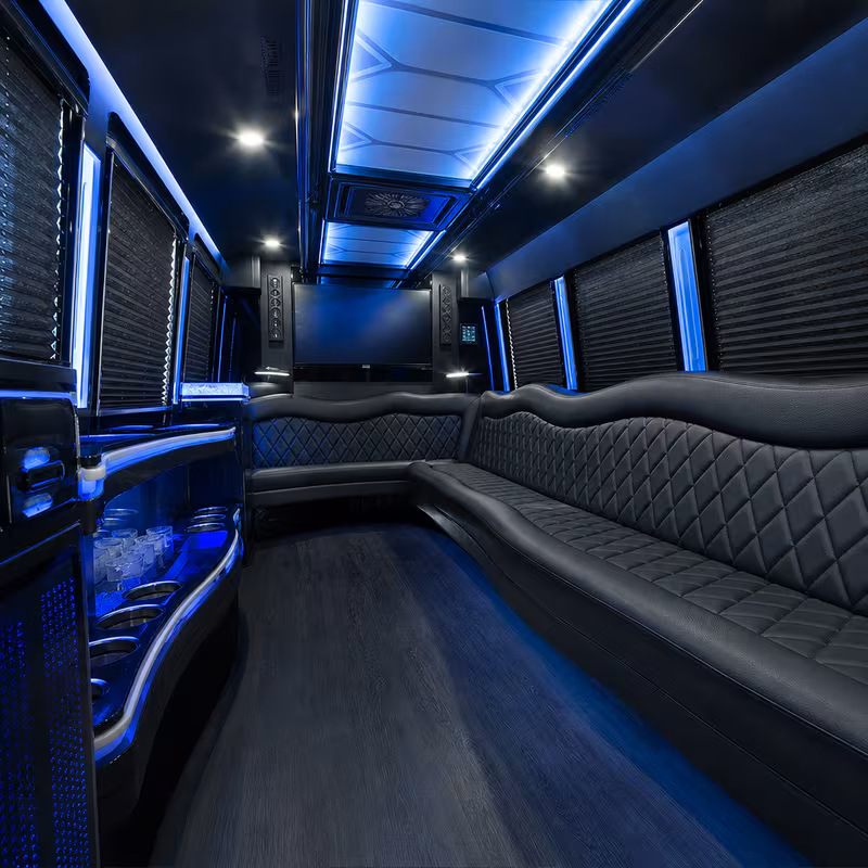 Party bus interior with wraparound leather seating and LED lighting in Newark