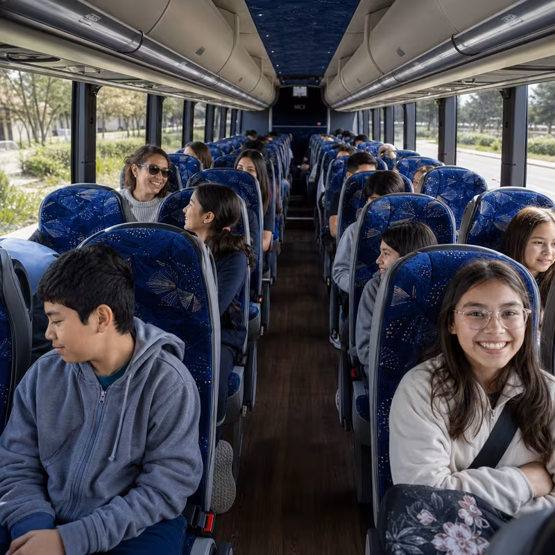 Group boarding a white charter bus for School Transportation transportation in Newark