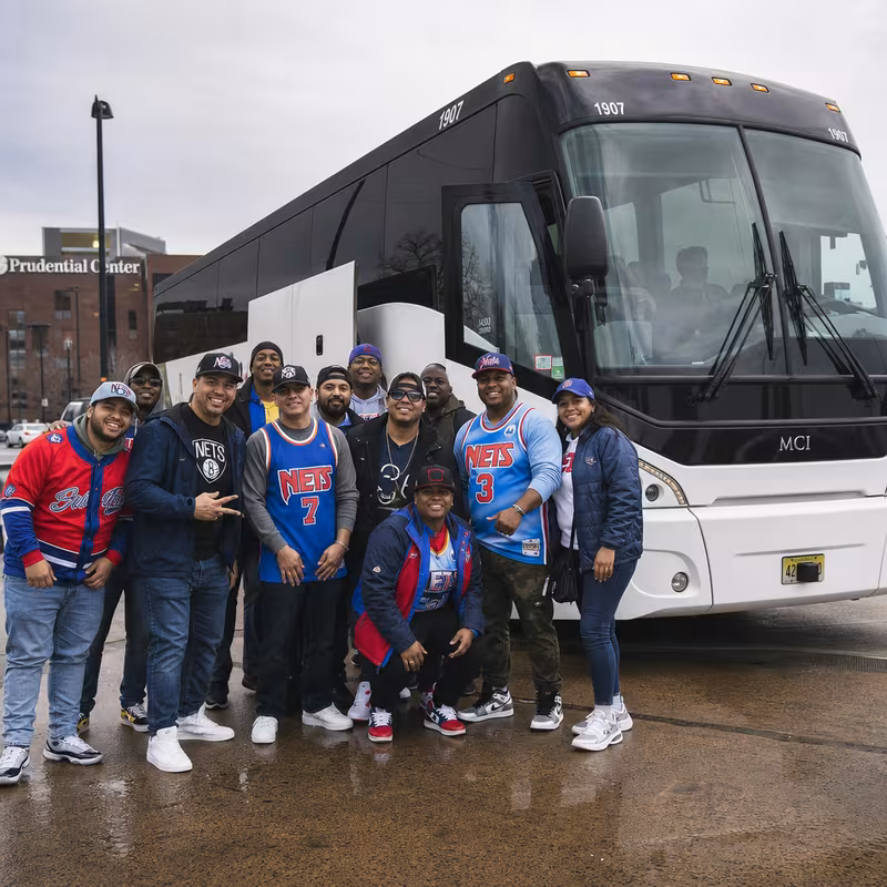 Passengers loading luggage while boarding an Newark group shuttle