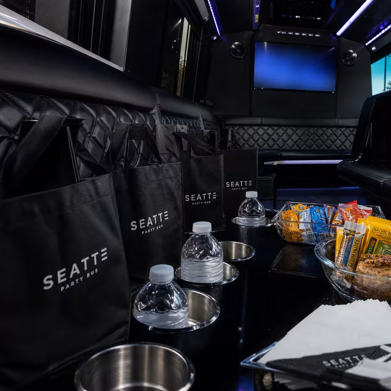 Party bus interior with wraparound leather seating and LED lighting in Newark